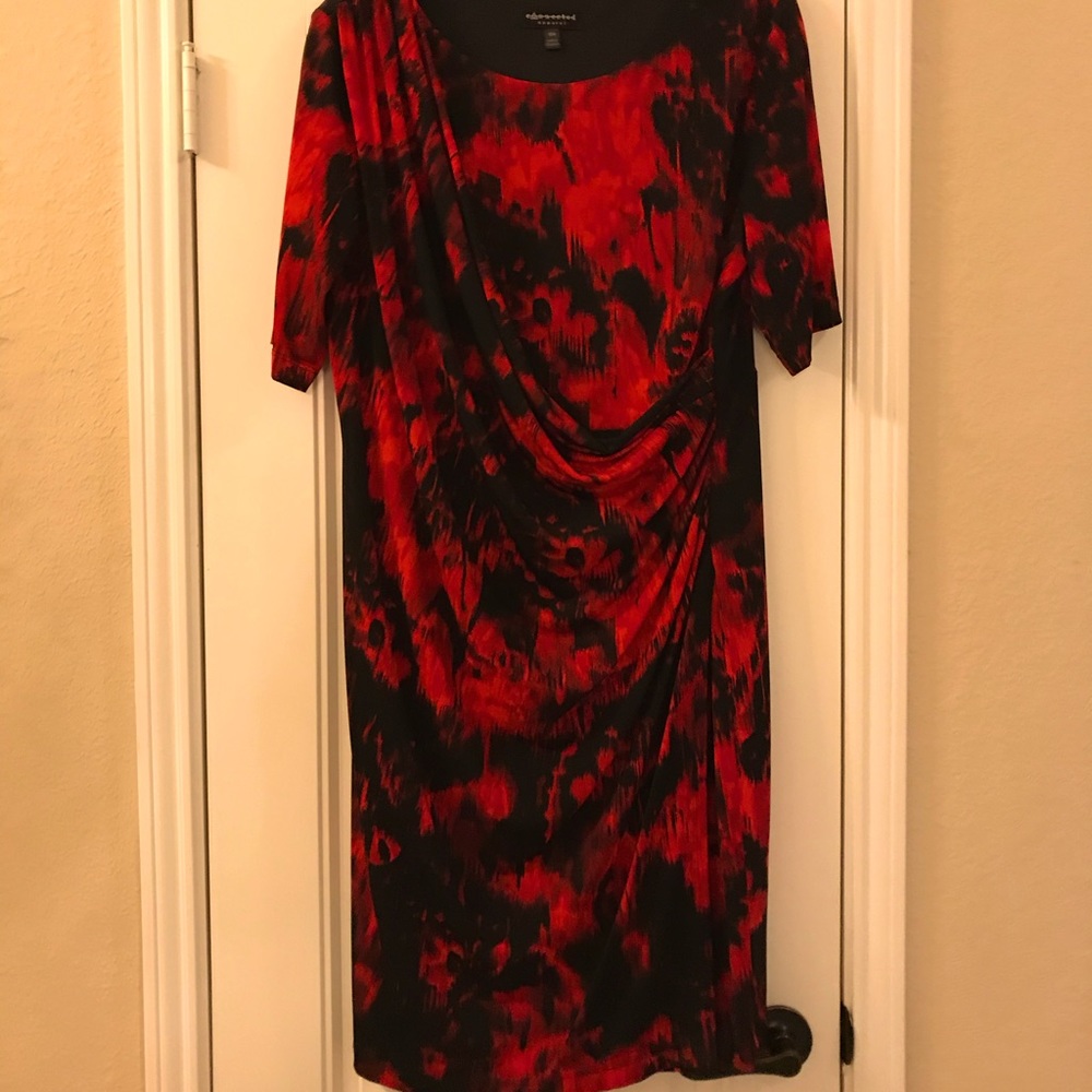 A red and black waist complimenting wraplike dress